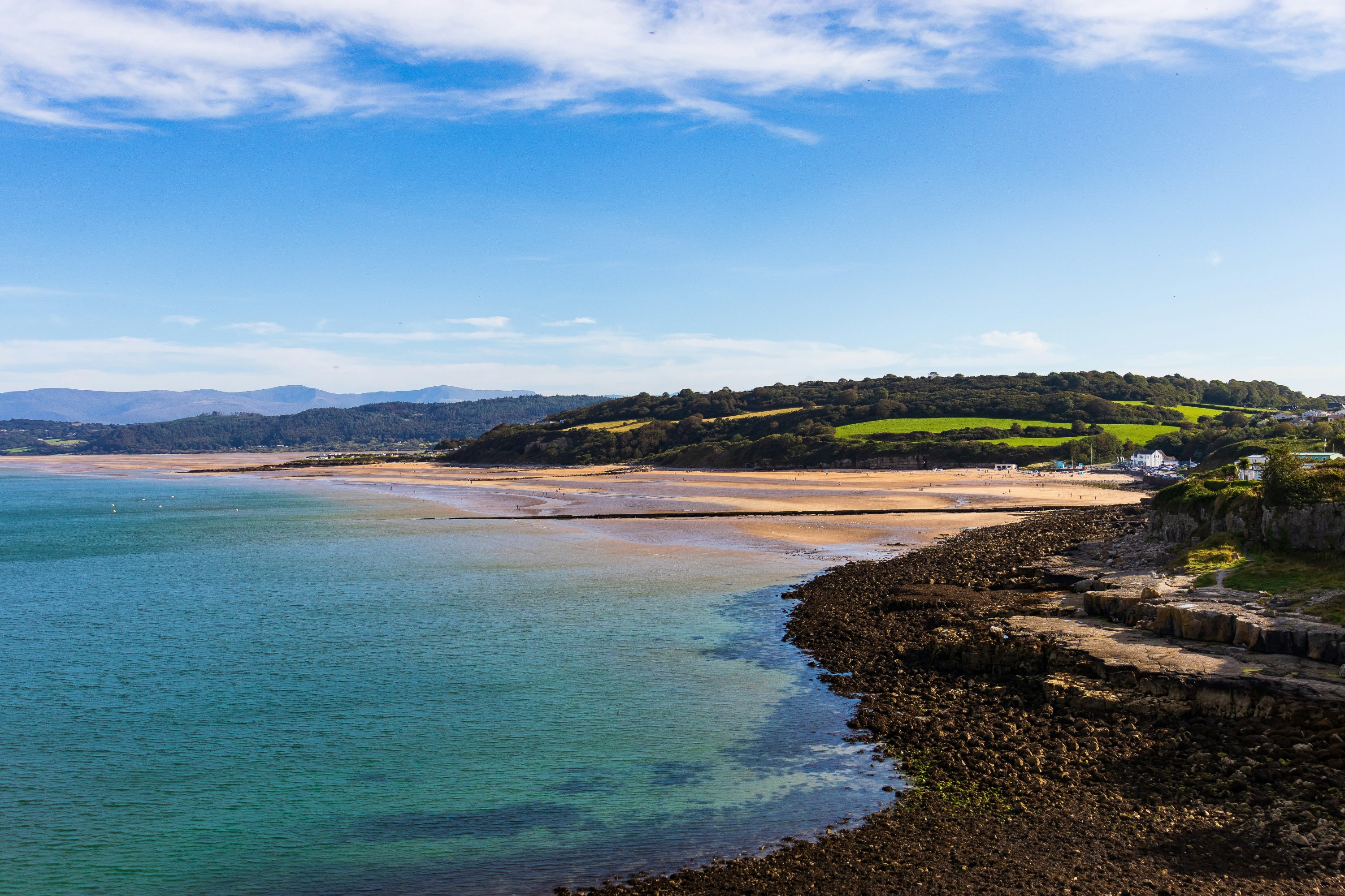 Benllech holiday cottages by Oyster. Panoramic view of Benllech beach.