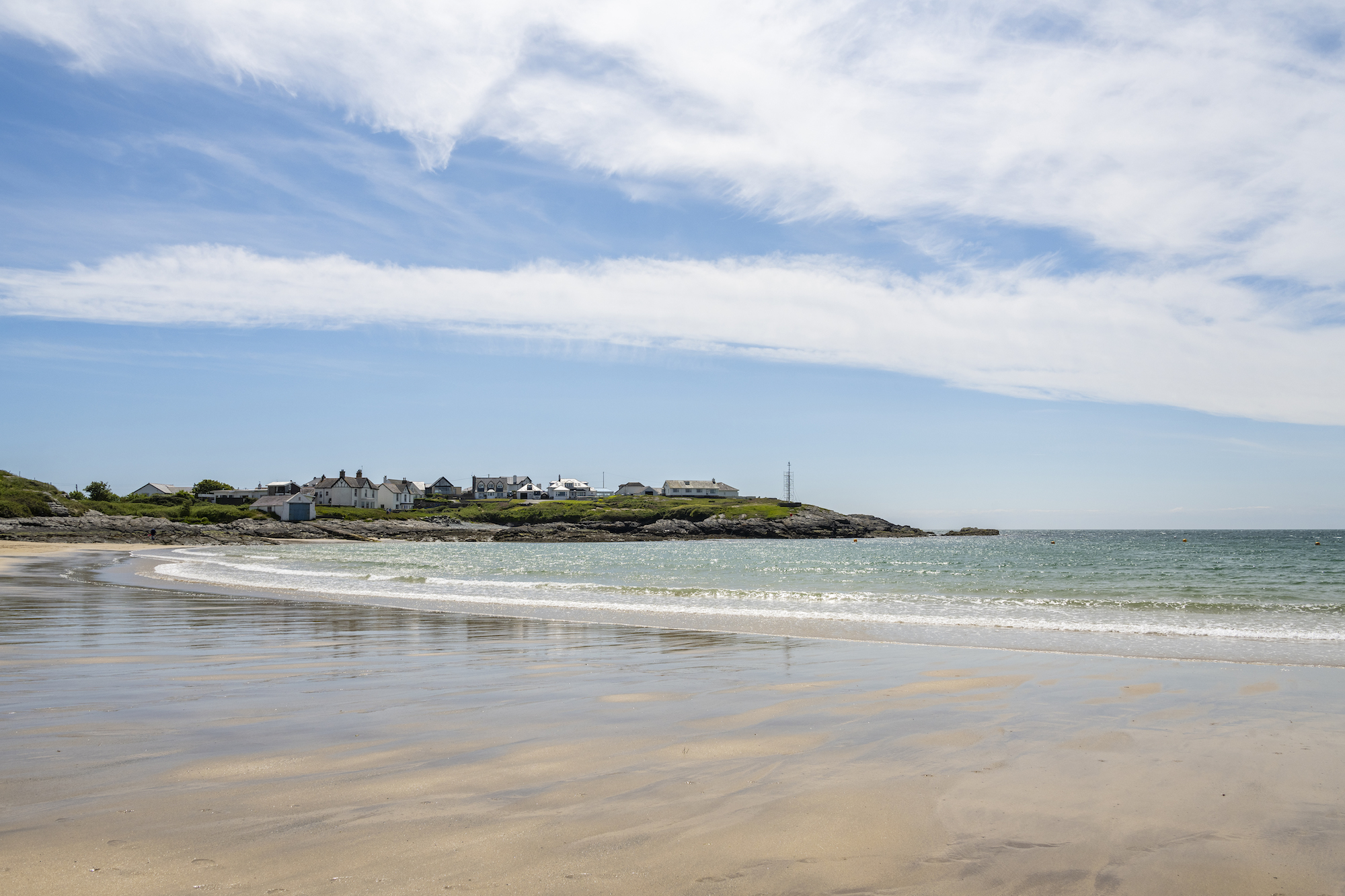 Trearddur Bay Accommodation from Oyster Holiday Cottages. A view across a golden sandy beach. 