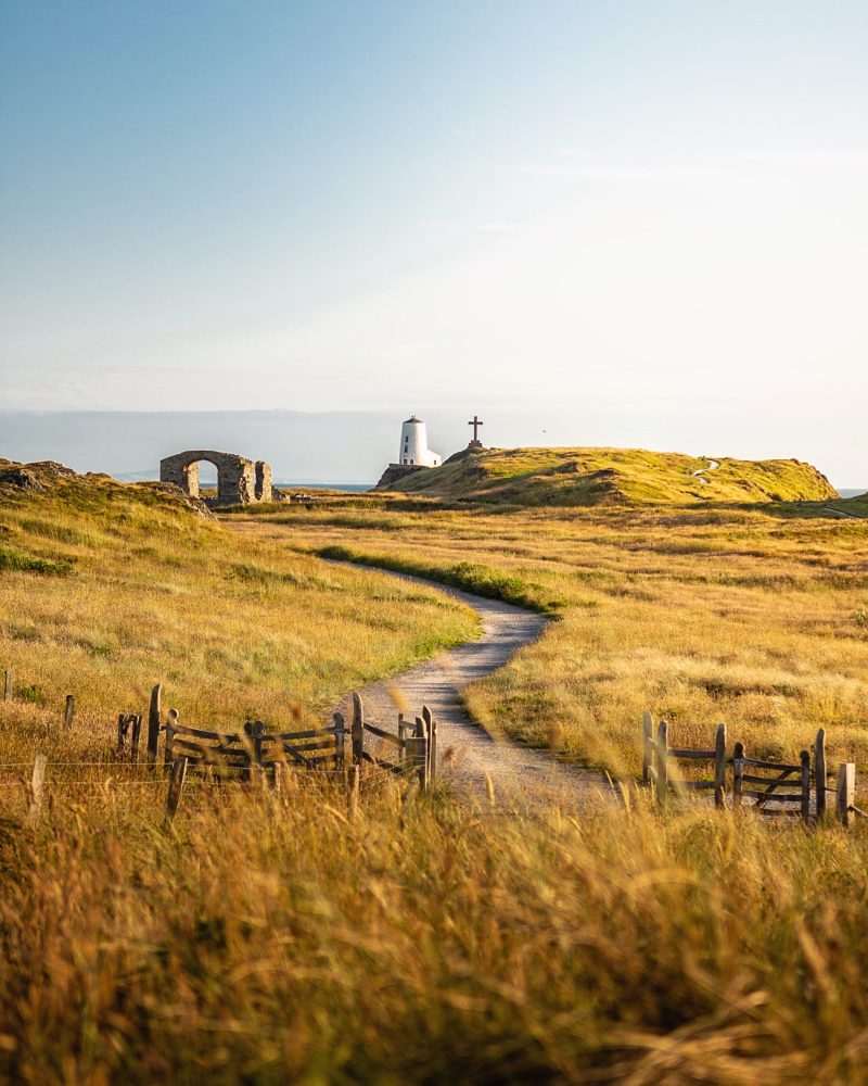 Coastal foothpath approaching Tŵr Mawr lighthouse on Llanddwyn Island, Anglesey, overlooking the Irish Sea