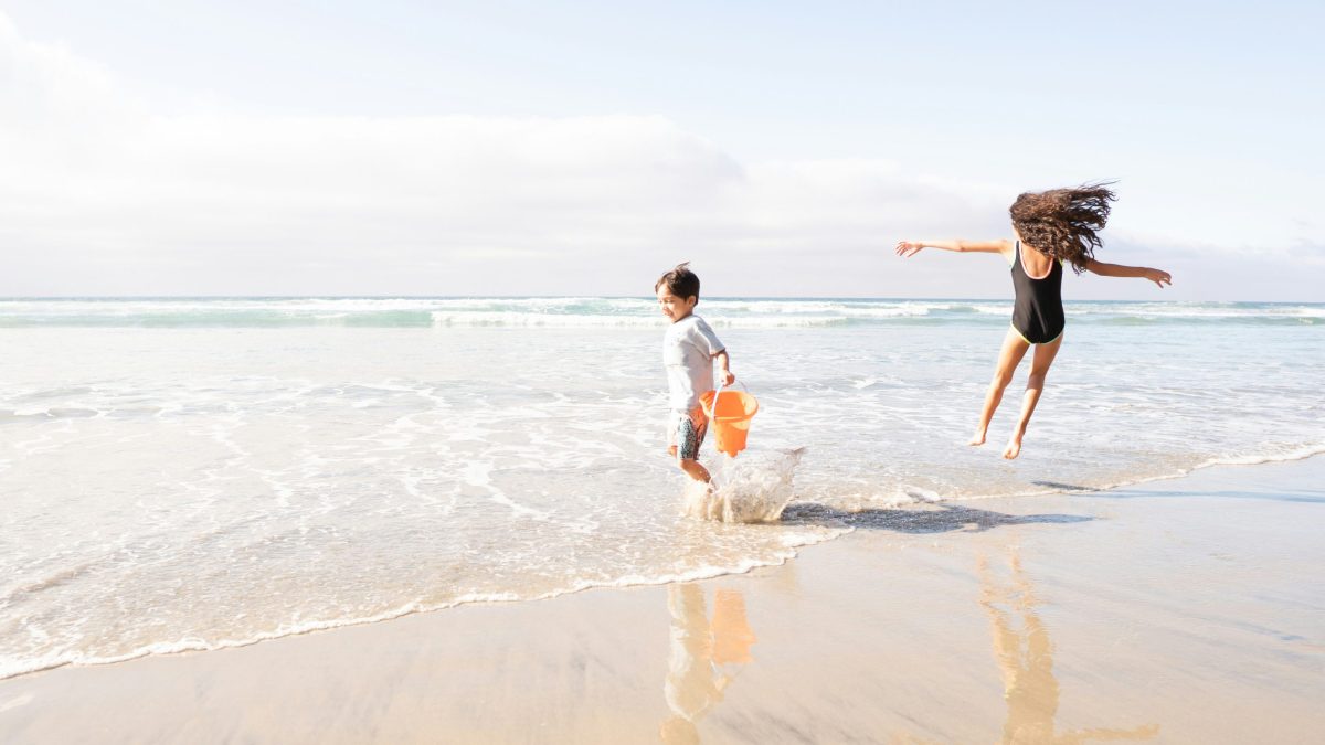 Two children playing on the beach. Free things to do in north Wales with kids.
