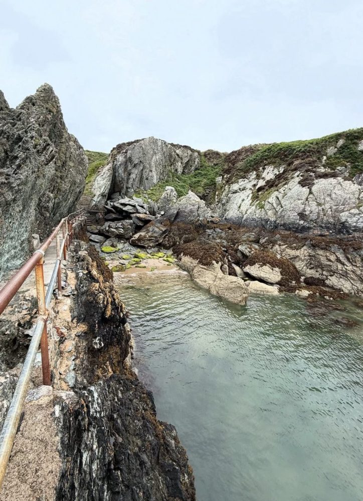 The metal railings at Porth Dynion, one of North Wales' best sea swimming spots