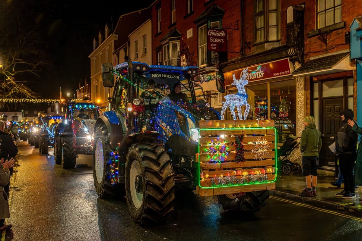 An illuminated tractor parade making its way through the streets of Llangollen
