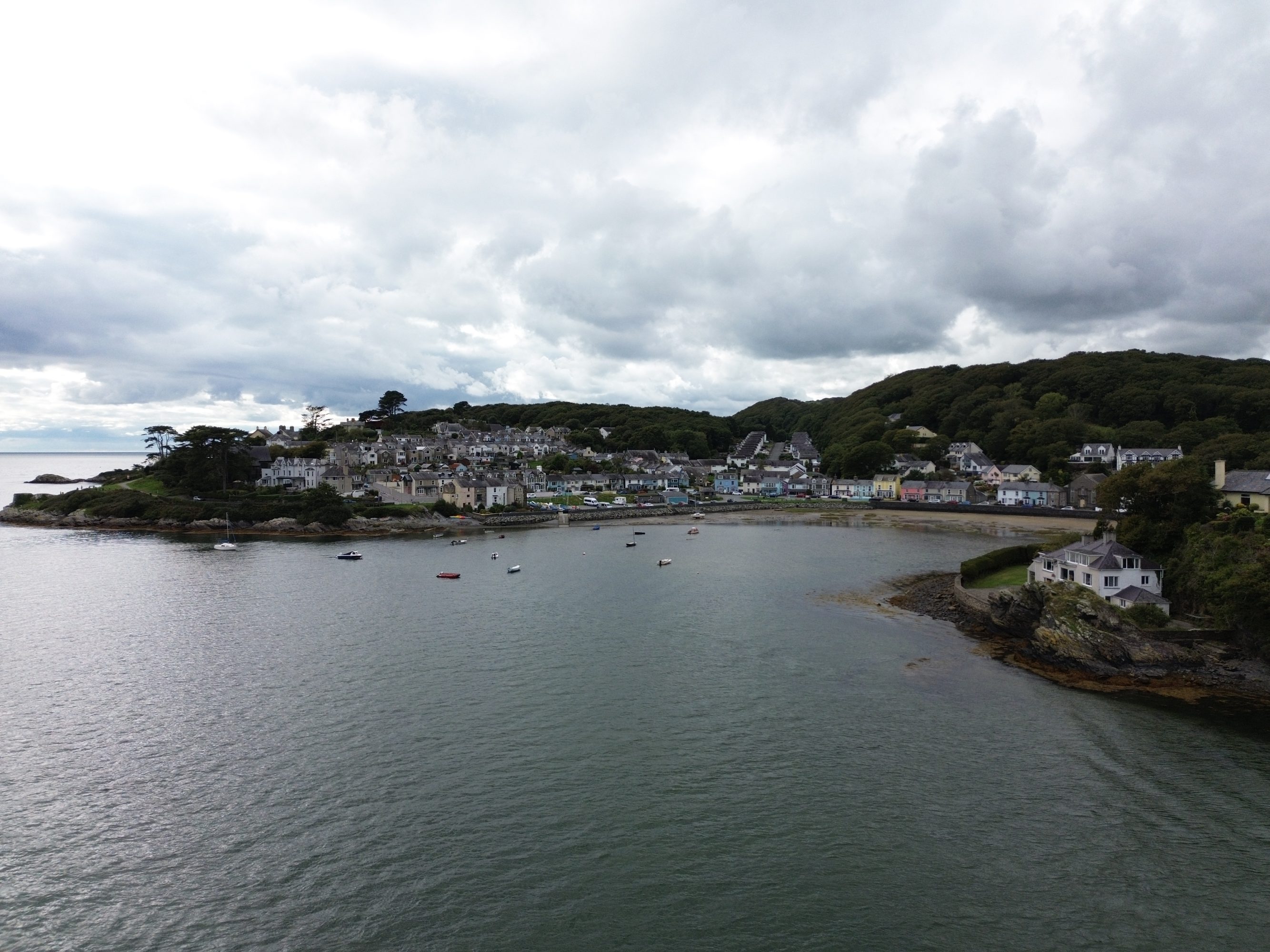 Borth y Gest holiday homes from Oyster Holiday Cottages. Drone view over Borth y Gest beach and colourful houses.