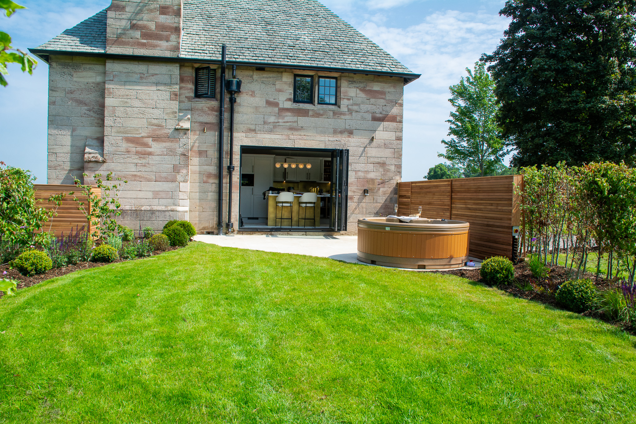 Holiday Cottage in Cheshire. Garden shot with hot tub at Liongate Lodge on the Bolesworth Estate in Cheshire.
