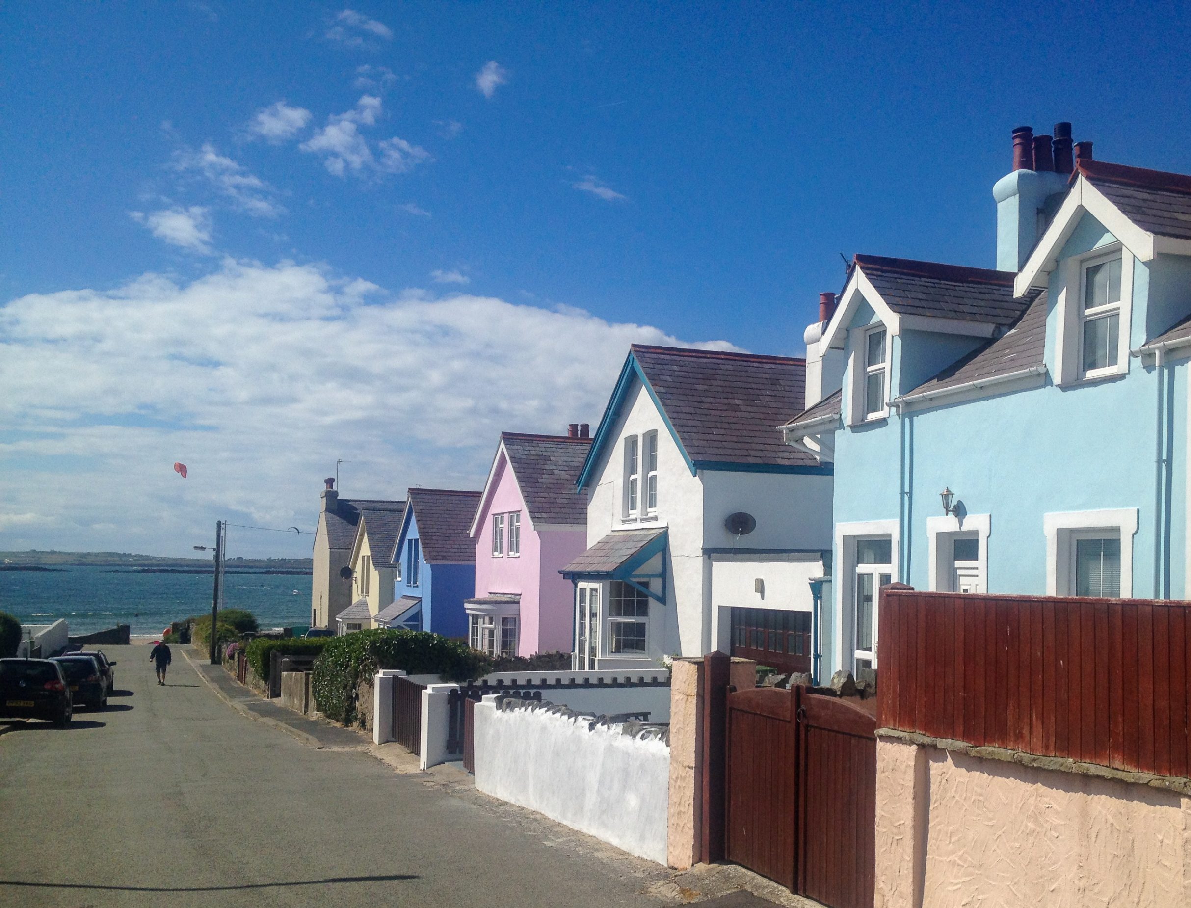 Colourful row of houses, featuring Ty Haf holiday cottage on the beachfront in Rhosneigr, Anglesey