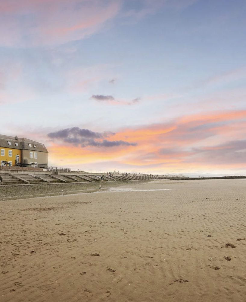 Prestatyn Central Beach, a Blue Flag sandy beach on the North Wales coast with lifeguards and the promenade of the seaside resort town behind