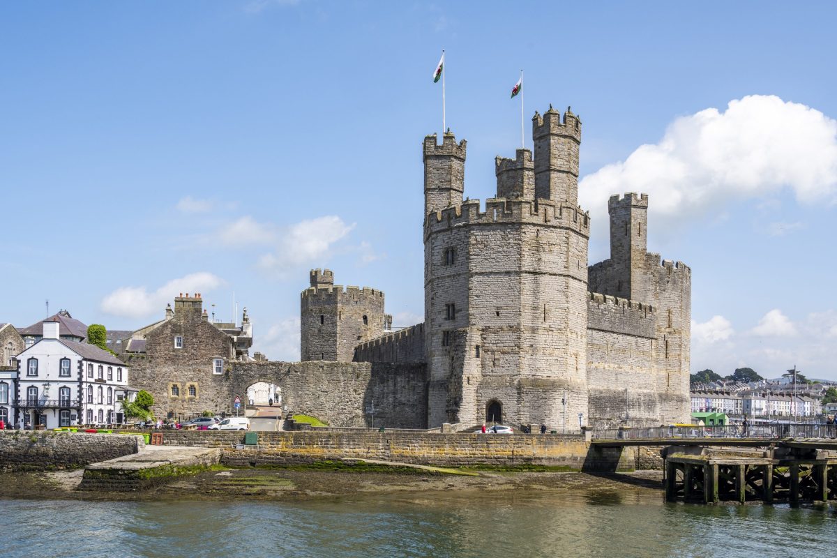 Caernarfon castle seen from across the water on a sunny day
