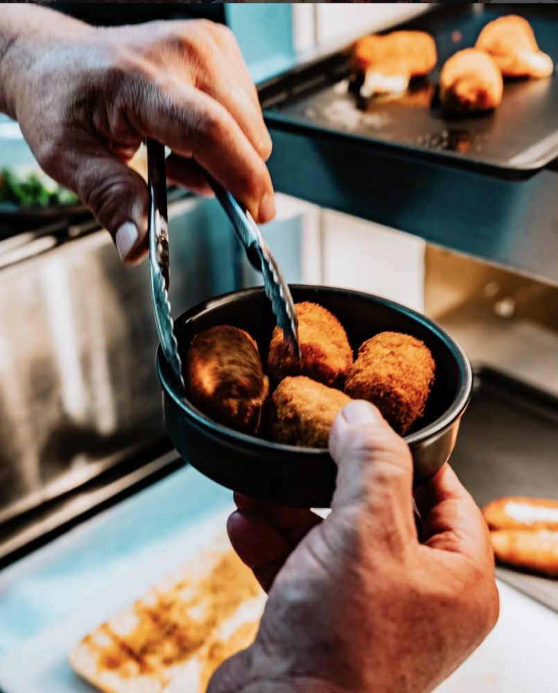 Tapas dishes being plated up in the kitchen at Diego's kitchen, Pwllheli
