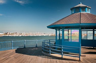 A scenic blue shelter on a pier overlooking Pwllheli marina